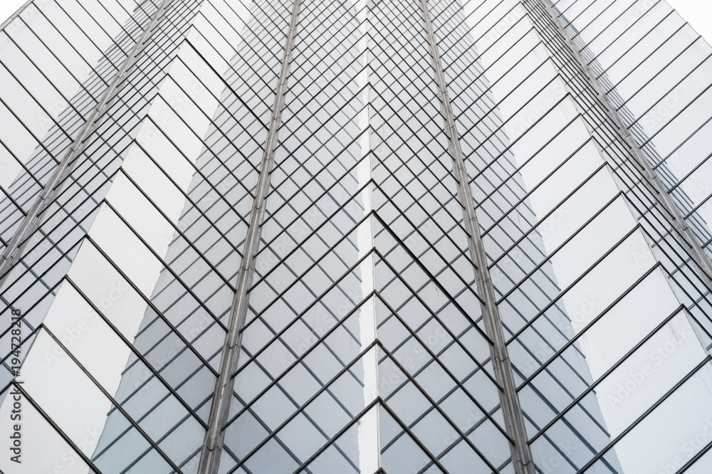 Glass surface of skyscrapers view in district of business centers with reflection on it, black and white Glass surface of skyscrapers view in district of business centers with reflection on it, black and white