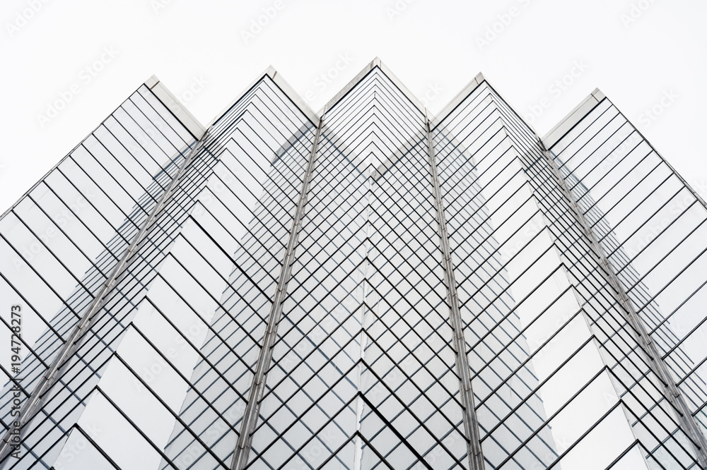 Glass surface of skyscrapers view in district of business centers with reflection on it, black and white Glass surface of skyscrapers view in district of business centers with reflection on it, black and white