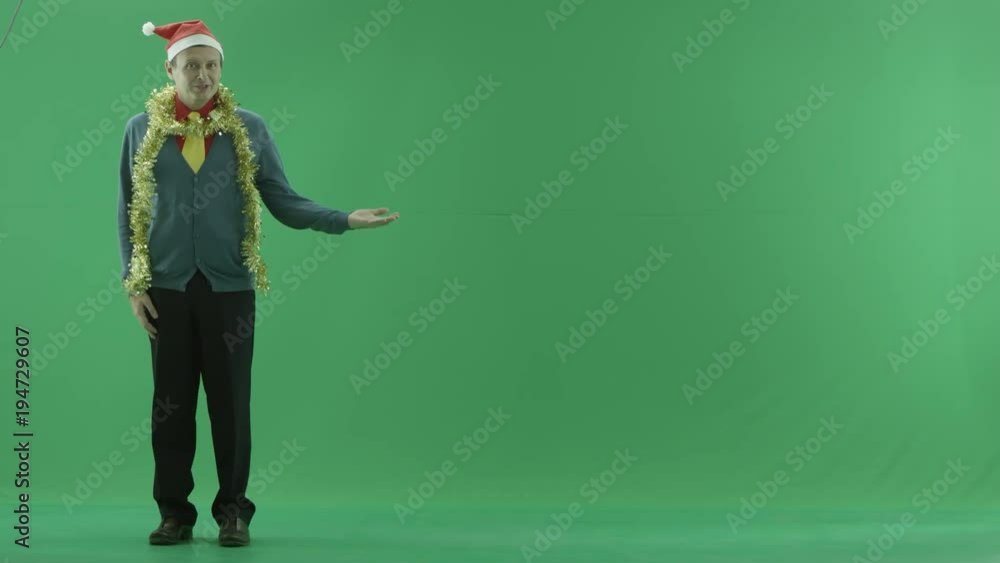 Mature man promotes something beside him, green chroma key background Mature man promotes something beside him, green chroma key background