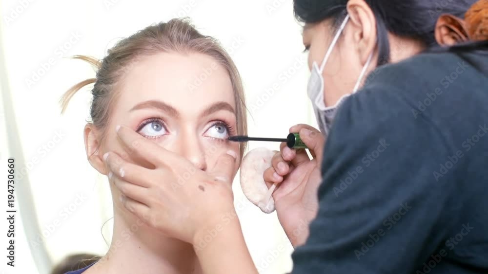 woman makeup her face at studio. Specialist doing makeup for model. woman makeup her face at studio. Specialist doing makeup for model.