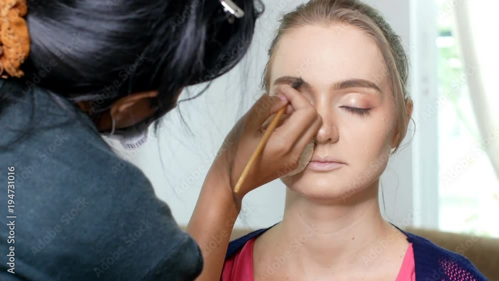 woman makeup her face at studio. Specialist doing makeup for model. woman makeup her face at studio. Specialist doing makeup for model.
