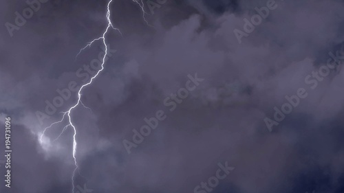 Powerful natural phenomenon, lightning forks striking in dark night sky