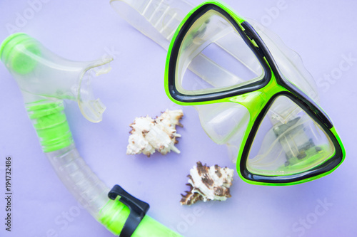 Vacation concept. Beach slippers and swimming mask on blue flat background, top view, flat lay photo