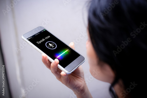 Voice recognition,search technology concept.Close-up of woman talking on her mobile phone photo