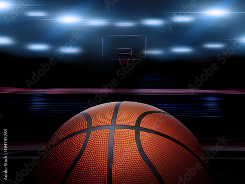 An indoor basketball court with an orange ball on an unmarked wooden floor under illuminated floodlights © Retouch man