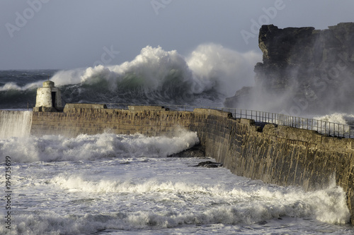 Massive wave towers over the entrance to Portreath harbour in north Cornwall