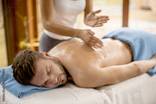 Young man having relax massage in the spa
