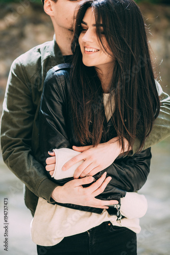 Spring photo session of a beautiful young couple in the old courtyards of the city.