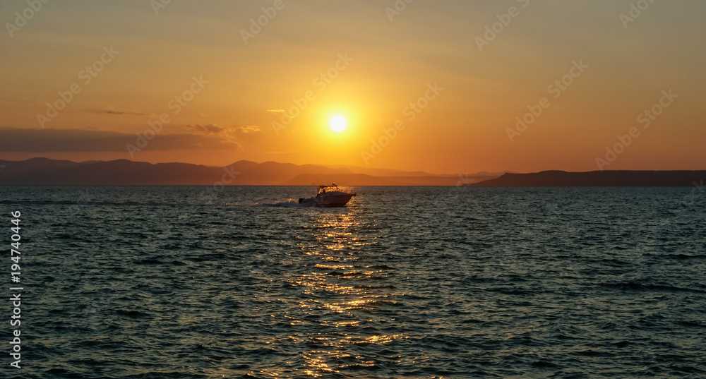 Boat at sunset, against sunlight