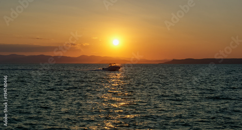 Boat at sunset  against sunlight
