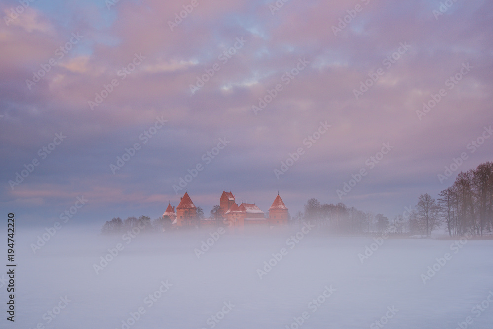 Castle floating in fog at winter