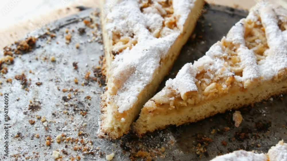 Pieces of half-eaten pie on a table. Homemade baking. Apple pie from short pastry in the home kitchen Pieces of half-eaten pie on a table. Homemade baking. Apple pie from short pastry in the home kitchen