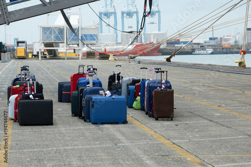 Suitcases of tourists of the sea liner at the unloading in the seaport