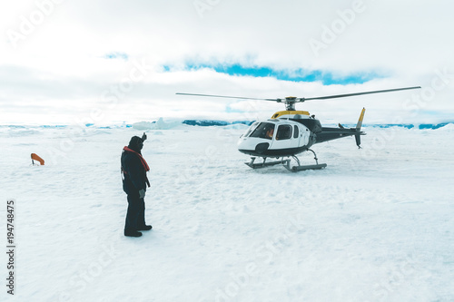 Helicopter taking off - Antarctica photo