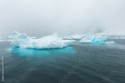 Pointed Ice Bergs tower out of the Ocean - Antarctica photo