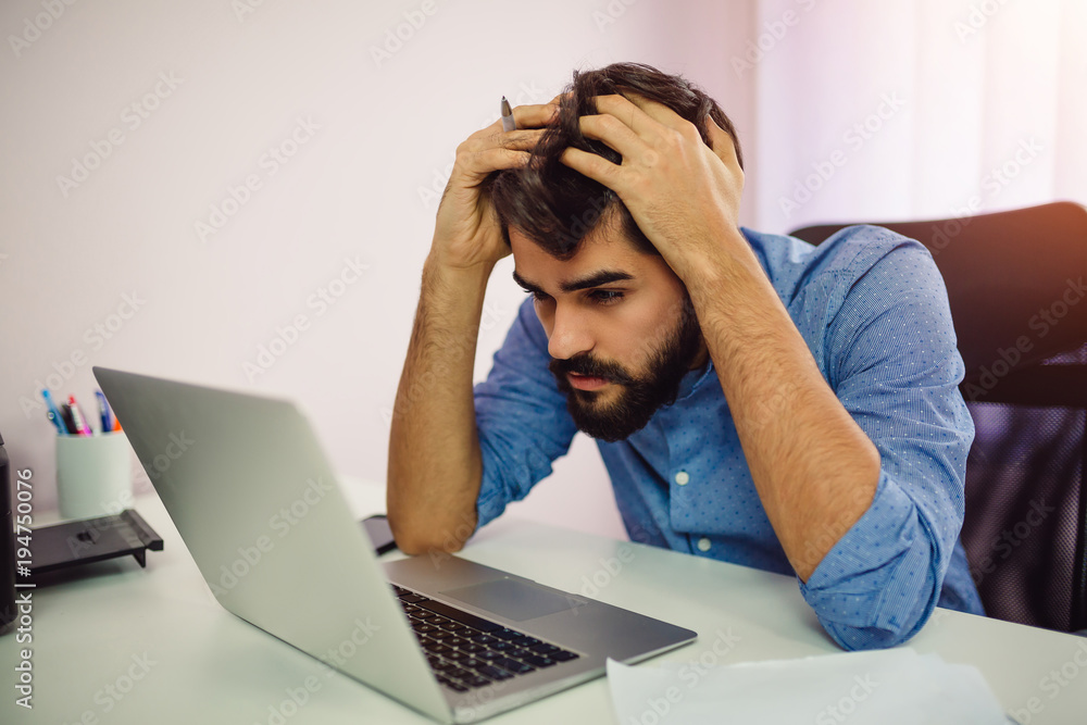 Worried businessman using laptop computer. Worried businessman using laptop computer.
