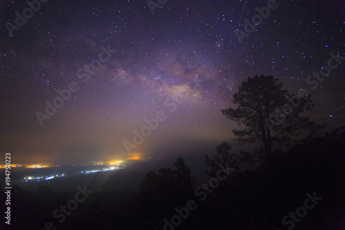 The Milky Way Galaxy and silhouette of trees in the mountains. Night scene landscape at Doi Dam view point Chiang mai, Thailand.