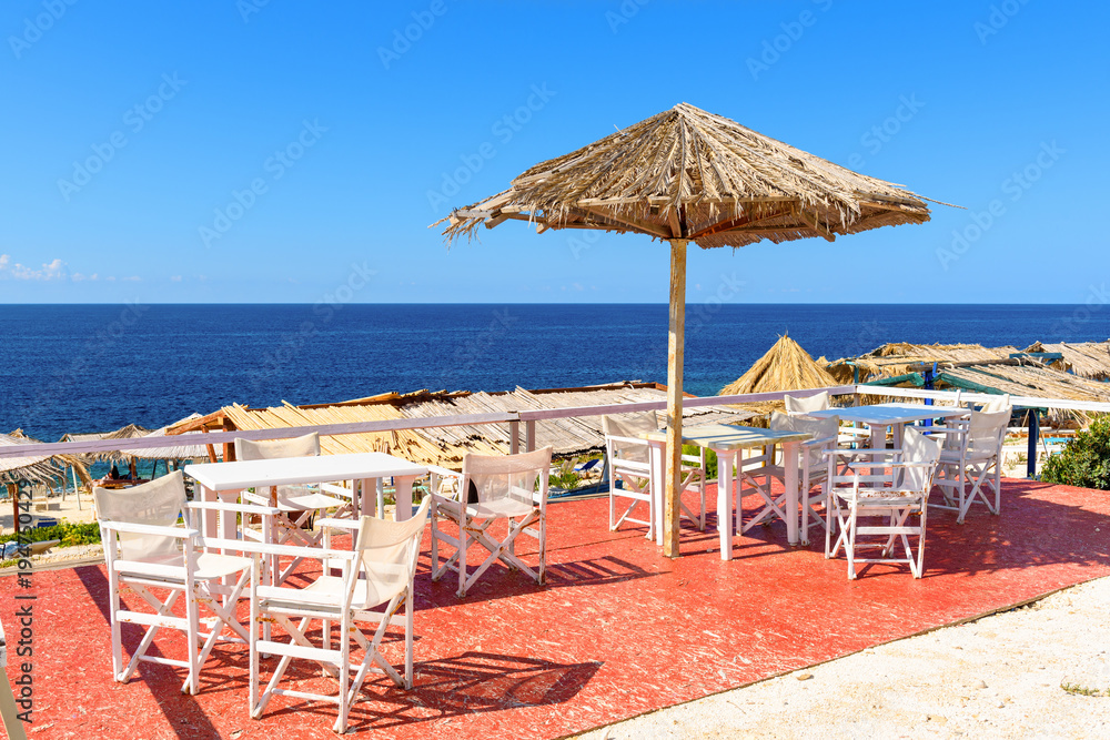 Tables and chairs on Porto Roxa beach. Zakynthos island, Greece