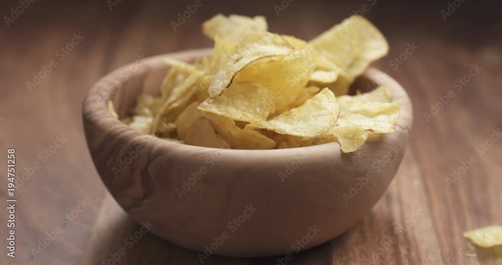 Slow motion closeup potato chip fall into bowl Slow motion closeup potato chip fall into bowl