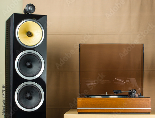 Принти на полотні Vintage turntable playing a vinyl record and modern black speakers