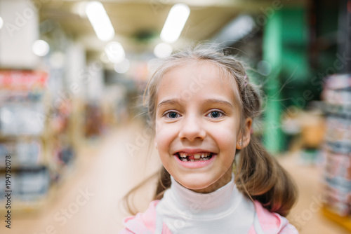Smiling little girl, happiness in pet shop
