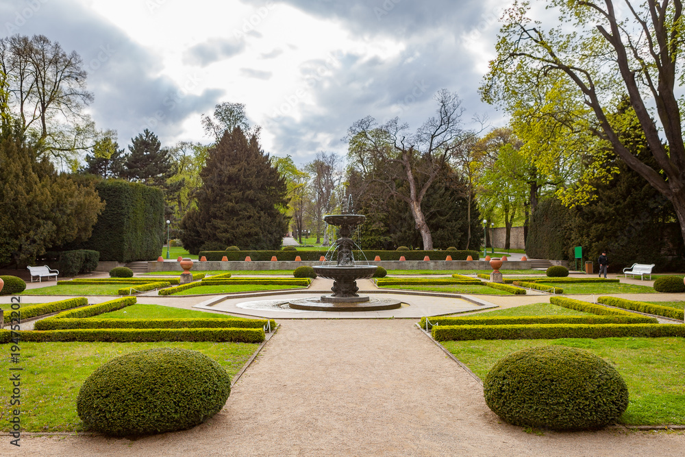 PRAGUE, CZECH REPUBLIC - APRIL, 25, 2017: The Singing Fountain in Kralovska Zahrada the Royal Gardens park in Hradcany. Luxury park style. PRAGUE, CZECH REPUBLIC - APRIL, 25, 2017: The Singing Fountain in Kralovska Zahrada the Royal Gardens park in Hradcany. Luxury park style.
