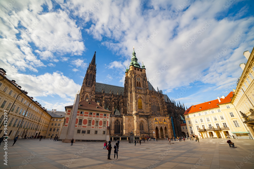 PRAGUE, CZECH REPUBLIC - APRIL 26, 2017: People walking by square around St. Vitus Cathedral in Prague, Czech Republic. Ultra wide view.