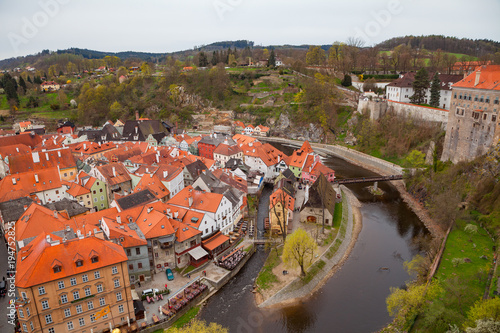 Wide panoramic view of Cesky Krumlov from the highest castle tower. Cloudy spring weather. UNESCO World Heritage Site