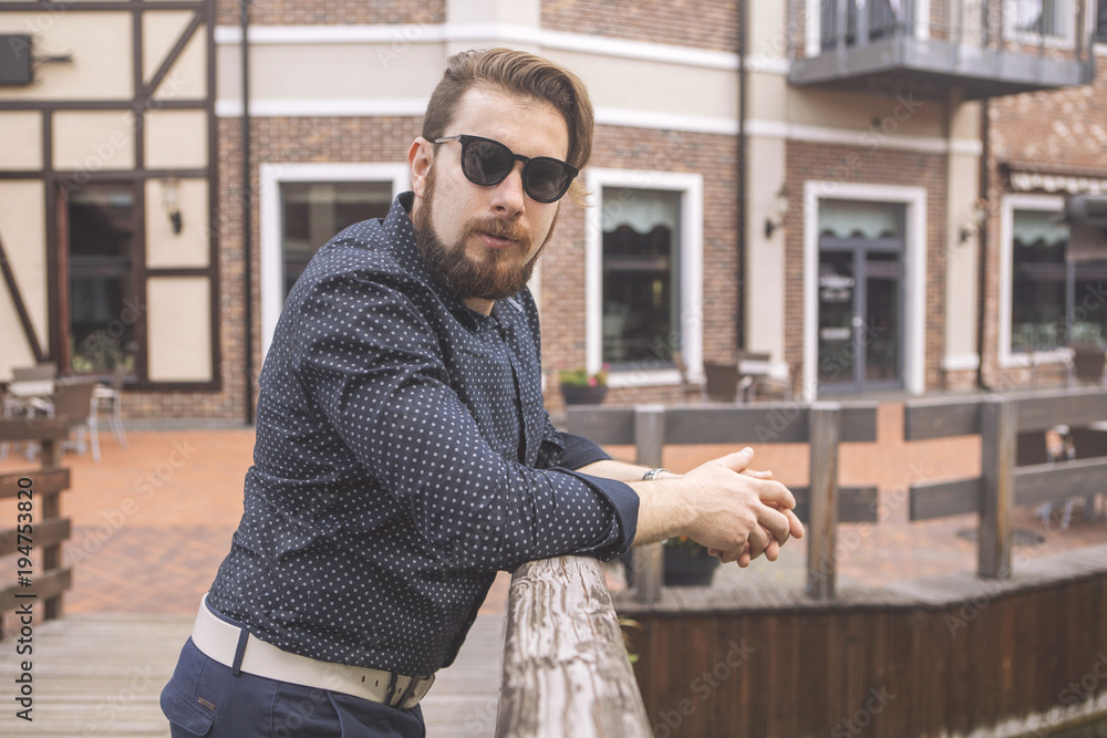 Happy caucasian man on a walk in european city, dressed in casual outfit. Summer daylight Happy caucasian man on a walk in european city, dressed in casual outfit. Summer daylight