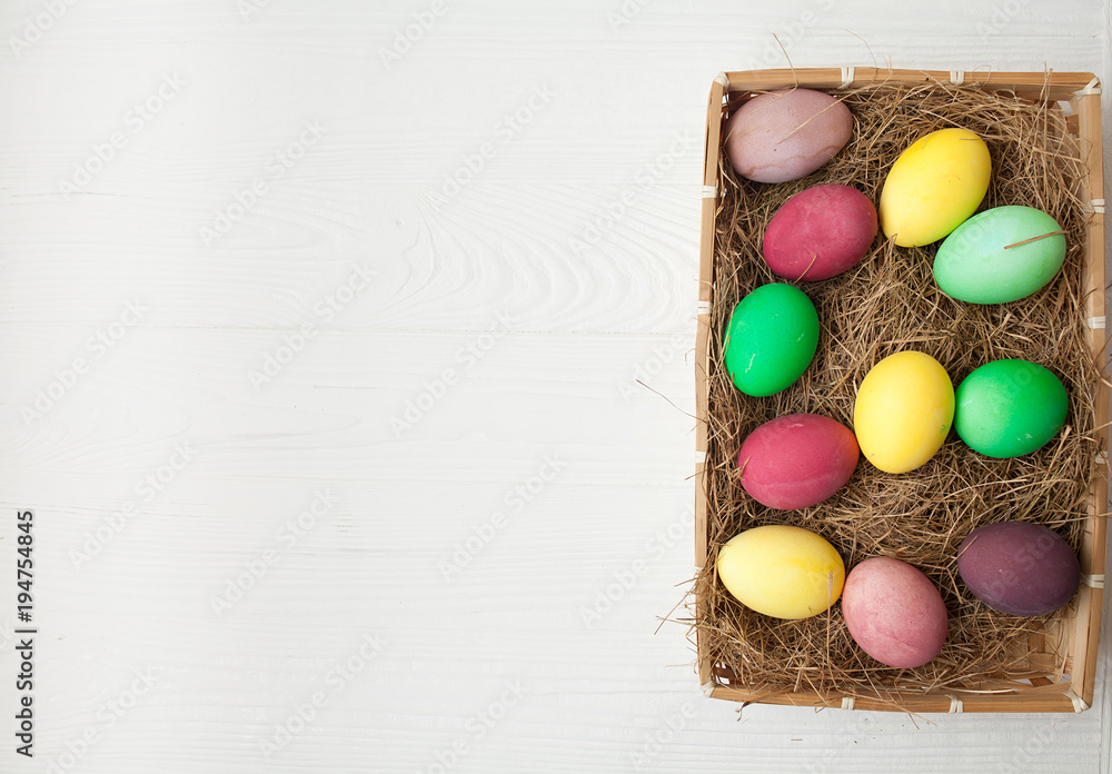 Easter eggs in the nest on white wooden background Easter eggs in the nest on white wooden background