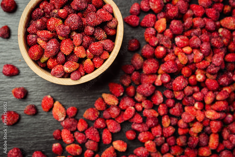 red strawberries in bowl on a wooden background red strawberries in bowl on a wooden background