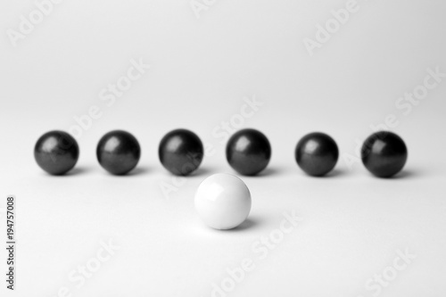 Decorative balls and one different on white background