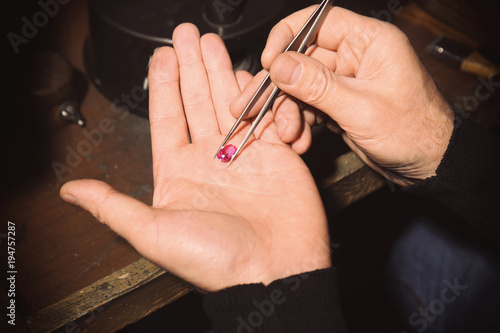 Jeweler examining gem in workshop  closeup