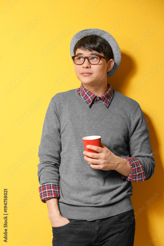 Portrait of handsome hipster in stylish outfit on color background Portrait of handsome hipster in stylish outfit on color background
