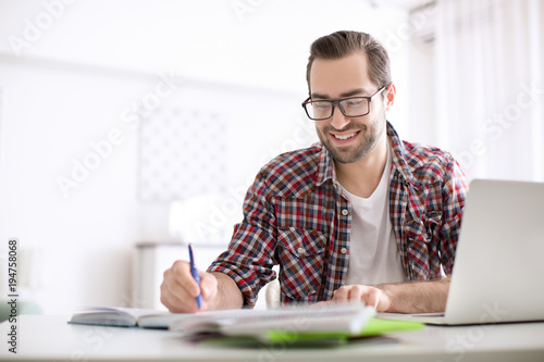 Student with laptop studyin...