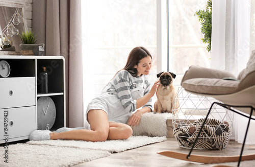 Woman with cute dog at home...
