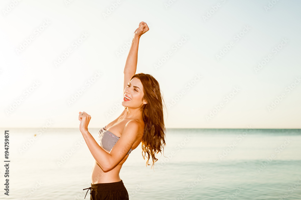 Beach vacation woman in sun smiling happy on summer holidays on tropical beach. Beach vacation woman in sun smiling happy on summer holidays on tropical beach.