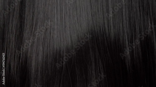 Hair texture background, no person. Black shiny hair goes to the light from dark