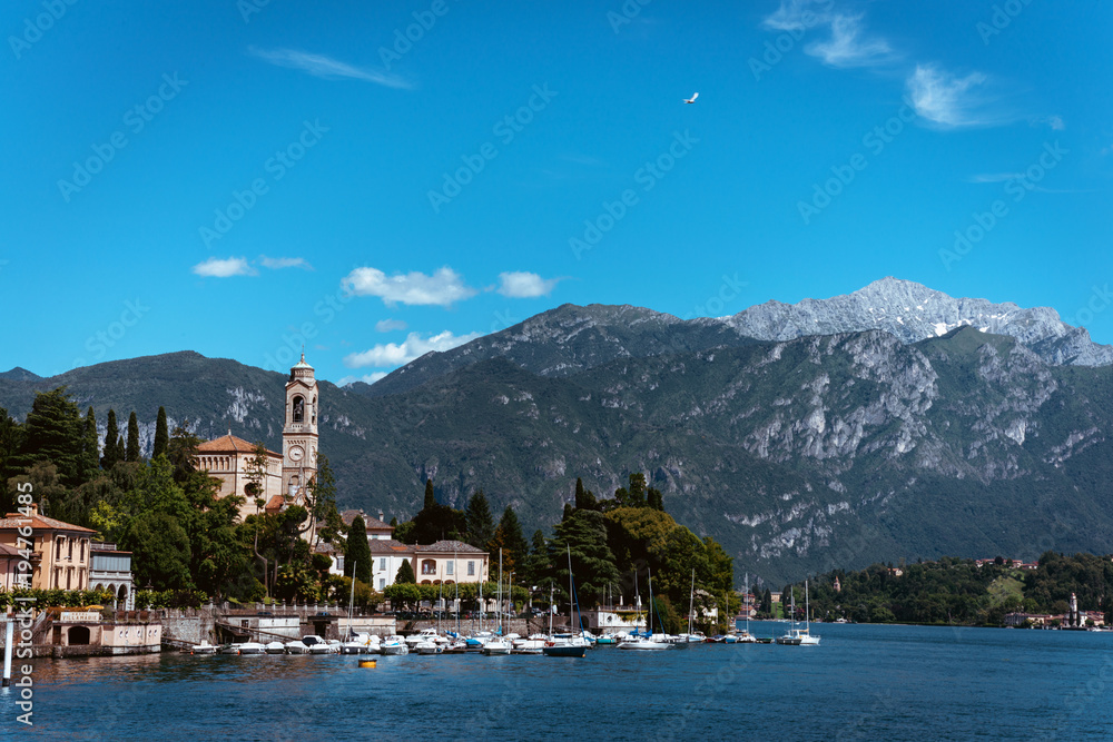 Amazing view of bright blue Como lake, Lombardy Italy, panorama of the lake and the city. Mountains on the background and good sunny summer weather Amazing view of bright blue Como lake, Lombardy Italy, panorama of the lake and the city. Mountains on the background and good sunny summer weather