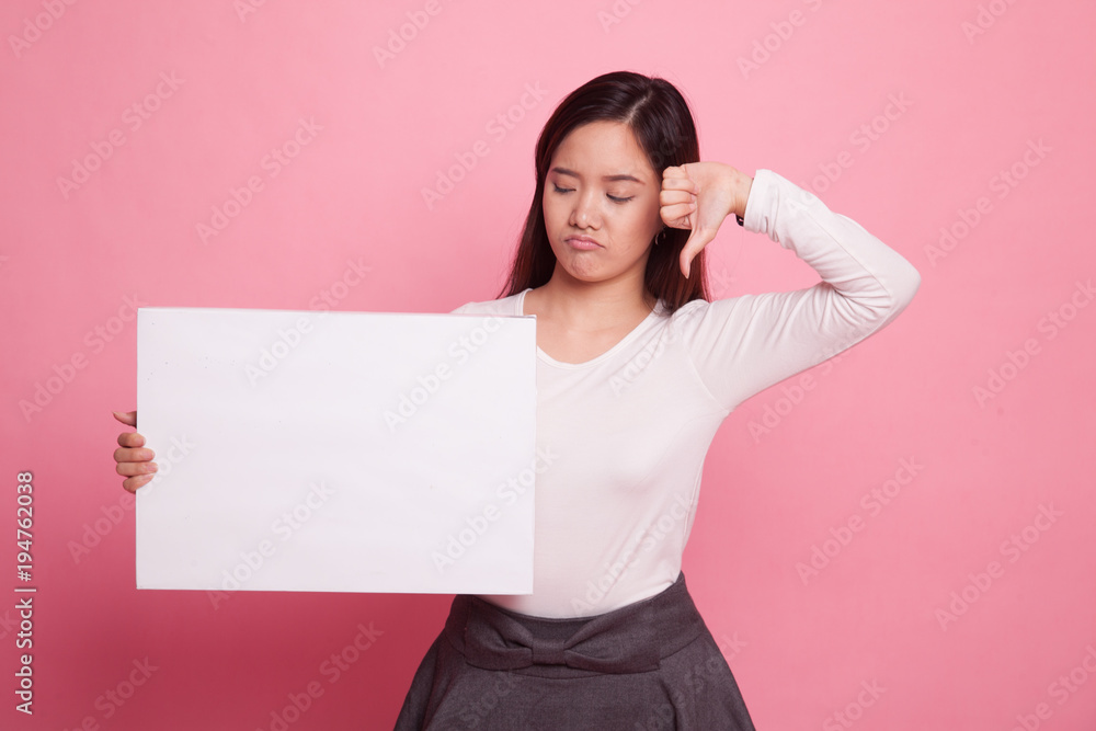 Young Asian woman show thumbs down with white blank sign. Young Asian woman show thumbs down with white blank sign.