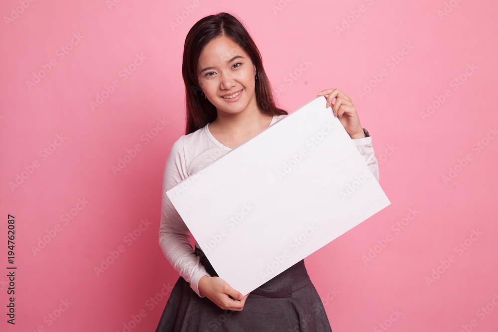 Young Asian woman with white blank sign. Young Asian woman with white blank sign.