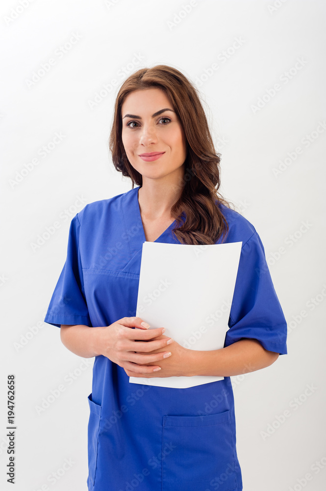 Smiling medical nurse in medical doctor uniform holding clipboard, isolated over white background. Smiling medical nurse in medical doctor uniform holding clipboard, isolated over white background.
