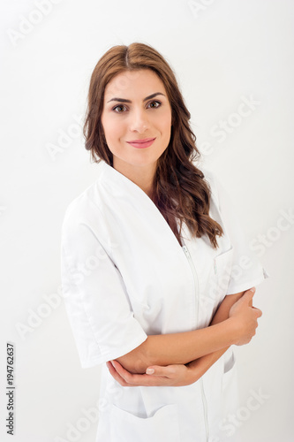 Smiling medical nurse in medical doctor uniform  isolated over white background.