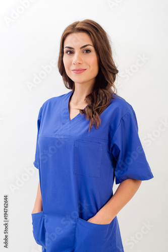 Smiling medical nurse in medical doctor uniform  isolated over white background.