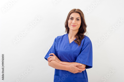 Smiling medical nurse in medical doctor uniform  isolated over white background. photo