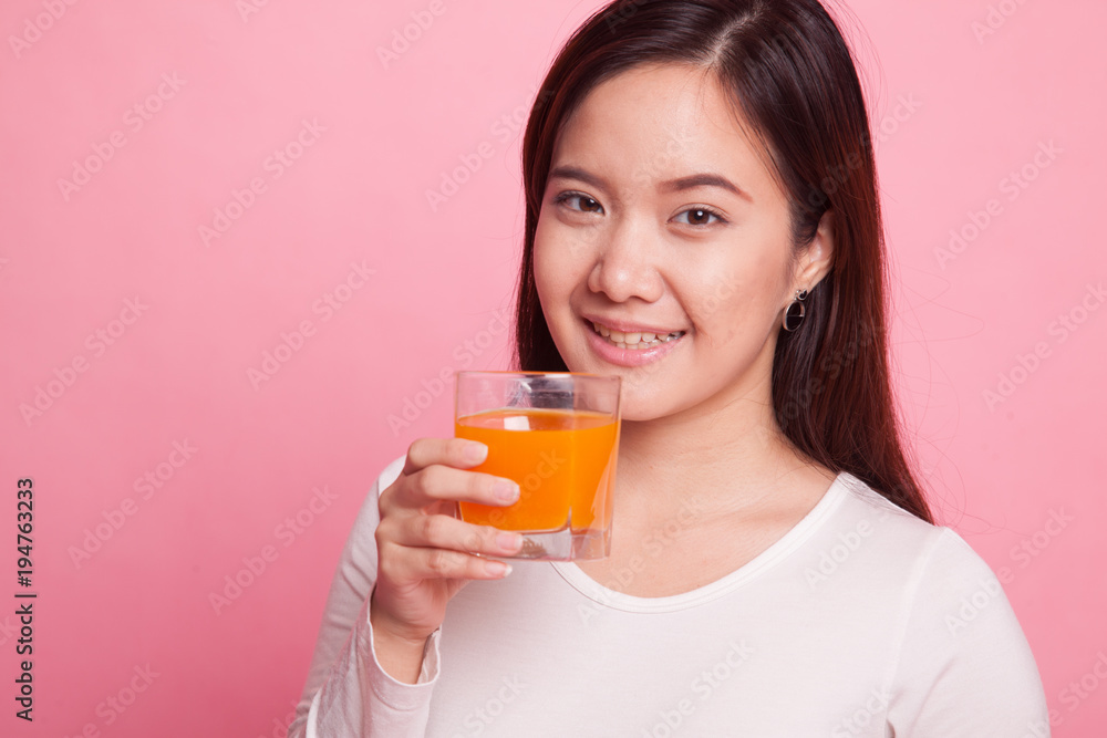 Young Asian woman drink orange juice. Young Asian woman drink orange juice.
