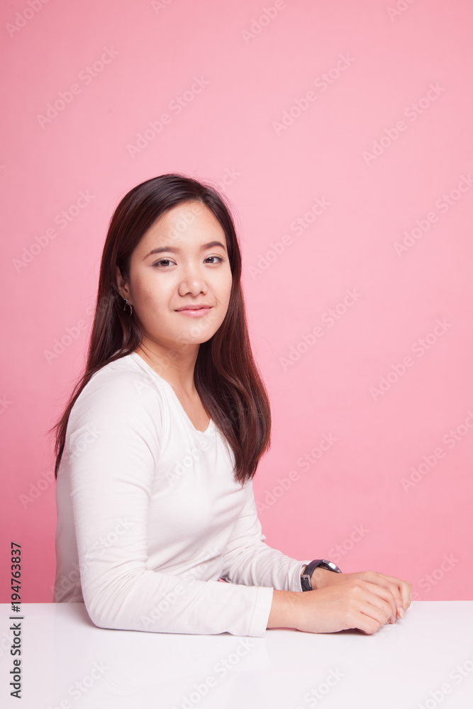 Beautiful young Asian woman smiling on pink background Beautiful young Asian woman smiling on pink background