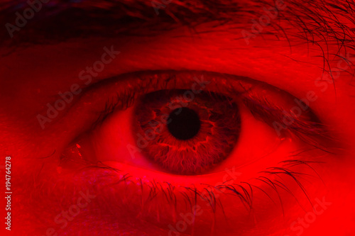 Macro on man eye expressing serious and expressionless expression