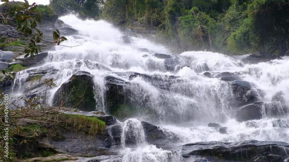 Close up.Pure fresh water waterfall in forest with black rocks. Close up.Pure fresh water waterfall in forest with black rocks.