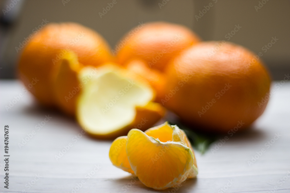 tangerines with leaves on wooden grey table
